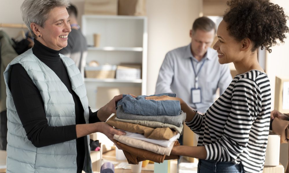 medium-shot-volunteers-with-clothes-donation